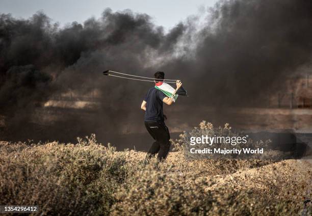 Palestinian demonstrators participate during a demonstration near the border between Israel and the Gaza Strip. A march organized by Palestinian...