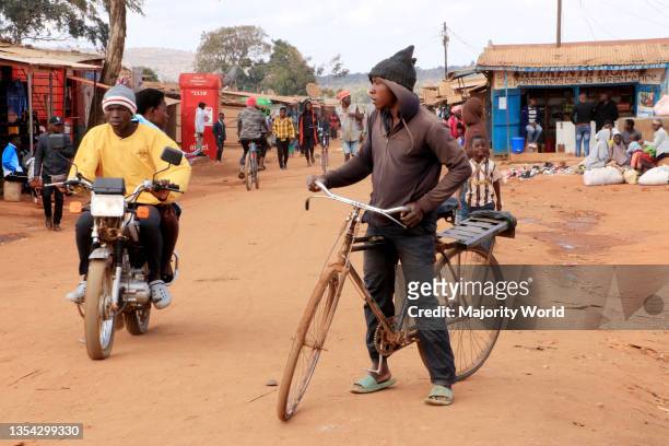 Two men are seen one on a motocycle and another on a bicycle at Dzaleka Refugee Camp. The motorcycle and bicycle are the commonest modes of transport...