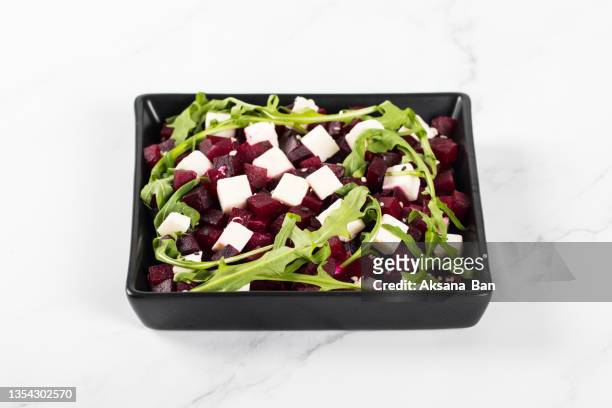 appetizer, salad made from beetroot, cottage cheese, diced, arugula with black and white sesame seeds in a salad bowl on a white background - cheese salad bildbanksfoton och bilder