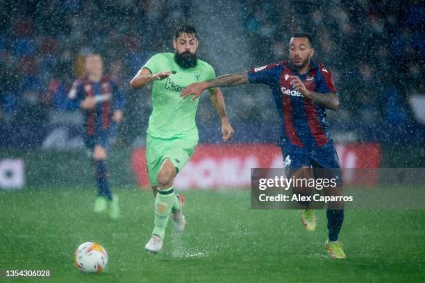 Asier Villalibre of Athletic Club competes for the ball with Ruben Vezo of Levante UD during the La Liga Santander match between Levante UD and...