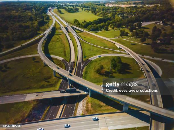 infrastructure interchange cargo transport long haul semi truck on a rural midwest usa interstate highway aerial photo series - truck smog stock pictures, royalty-free photos & images