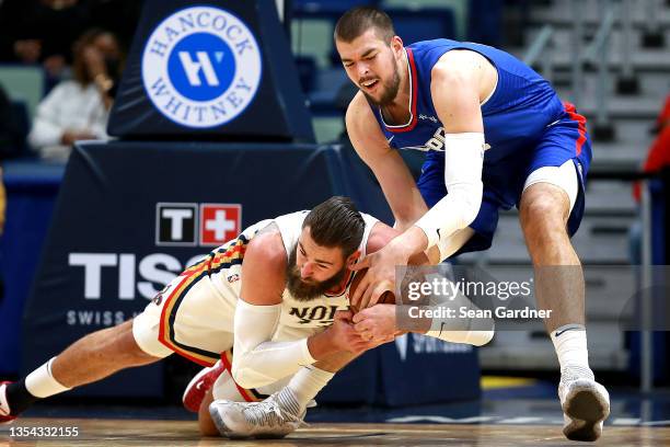 Ivica Zubac of the LA Clippers and Jonas Valanciunas of the New Orleans Pelicans go for a loose ball during the first quarter of a NBA game at...