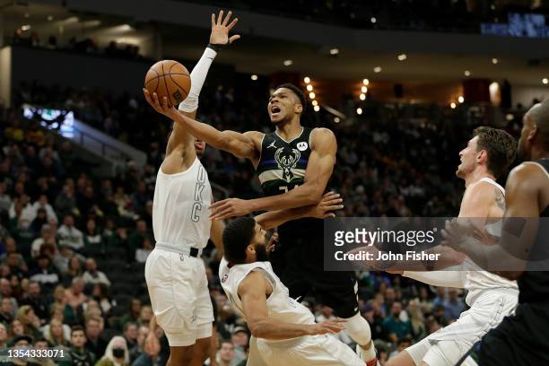 Giannis Antetokounmpo of the Milwaukee Bucks is called for a charge on Kenrich Williams of the Oklahoma City Thunder during the first half of a game...