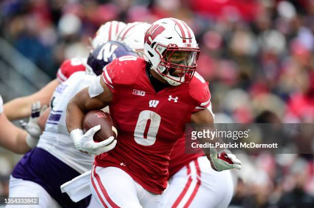Braelon Allen of the Wisconsin Badgers runs with the ball in the first half against the Northwestern Wildcats at Camp Randall Stadium on November 13,...