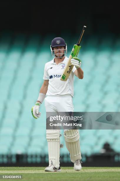 Daniel Hughes of New South Wales celebrates and acknowledges the crowd after scoring a half century during day one of the Sheffield Shield match...