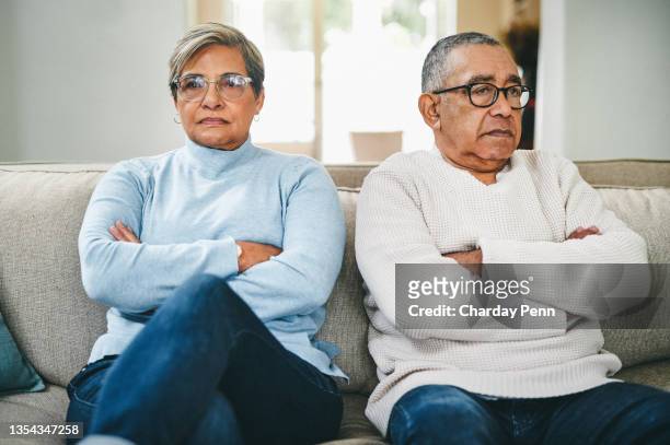 shot of a senior couple arguing at home - annoyed wife stock pictures, royalty-free photos & images