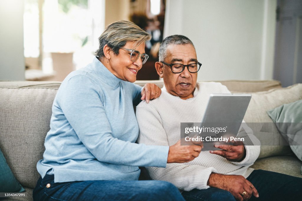 Shot of a senior couple using a digital tablet at home