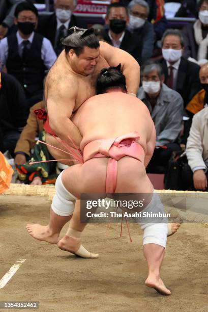 Ura pushes Takayasu out of the ring to win on day six of the Grand Sumo Kyushu Tournament at the Fukuoka Convention Center on November 19, 2021 in...