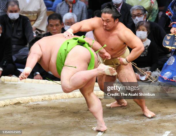 Ishiura throws Akua to win on day six of the Grand Sumo Kyushu Tournament at the Fukuoka Convention Center on November 19, 2021 in Fukuoka, Japan.