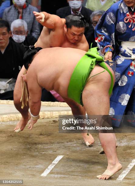 Ishiura throws Akua to win on day six of the Grand Sumo Kyushu Tournament at the Fukuoka Convention Center on November 19, 2021 in Fukuoka, Japan.