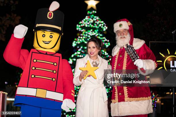 Actress Lacey Chabert poses for photos with a LEGO soldier and Santa Claus during LEGOLAND California Resort's 19th Annual Tree Lighting Ceremony at...