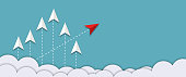 Red arrow among the white arrows changed direction on blue sky background.