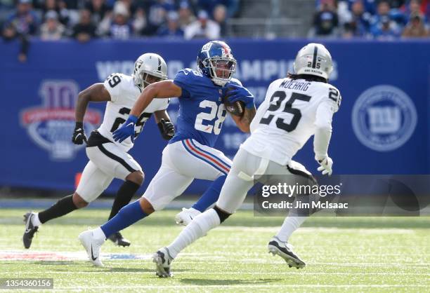 Devontae Booker of the New York Giants in action against Trevon Moehrig of the Las Vegas Raiders at MetLife Stadium on November 07, 2021 in East...