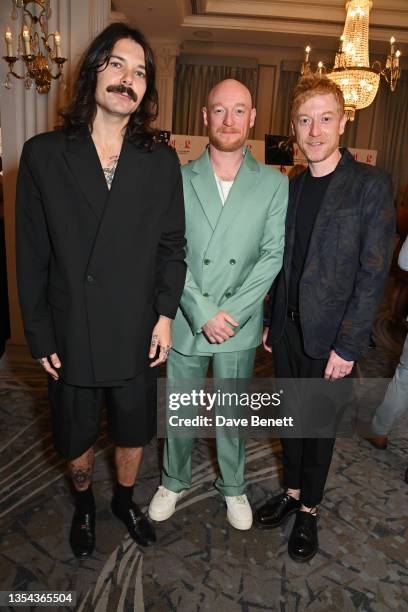 Simon Neil, Ben Johnston and James Johnston of Biffy Clyro pose in the press room during the Nordoff and Robbins O2 Silver Clef Awards at the JW...