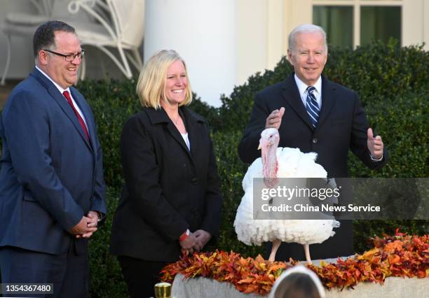 President Joe Biden pardons the turkey 'Peanut Butter' as Andrea Welp , turkey grower from Indiana, and Phil Seger, chairman of the National Turkey...