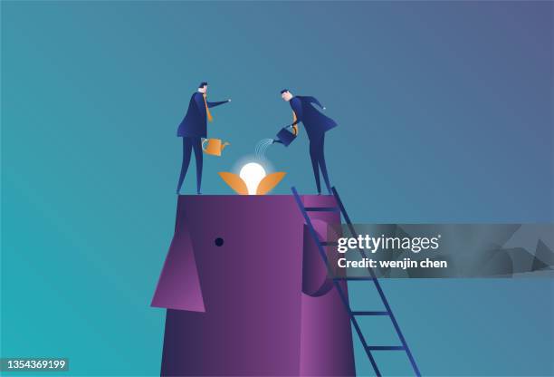 two business men water the bulb seedlings in the giant brain - on top of stock illustrations