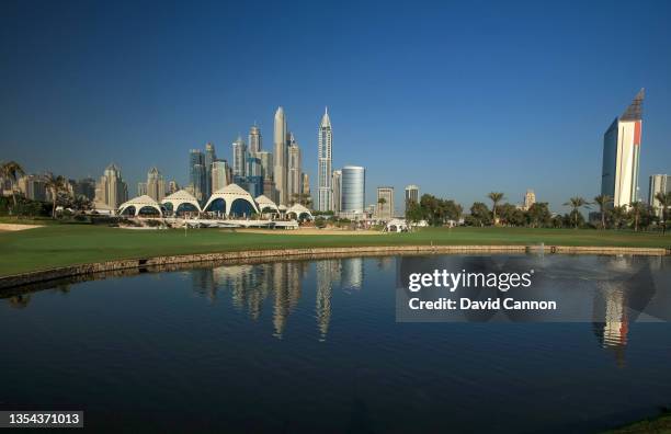 View of the double green of the par 5, 18th and the par 4, ninth holes with the clubhouse behind and the Dubai Marina skyline behind after complete...