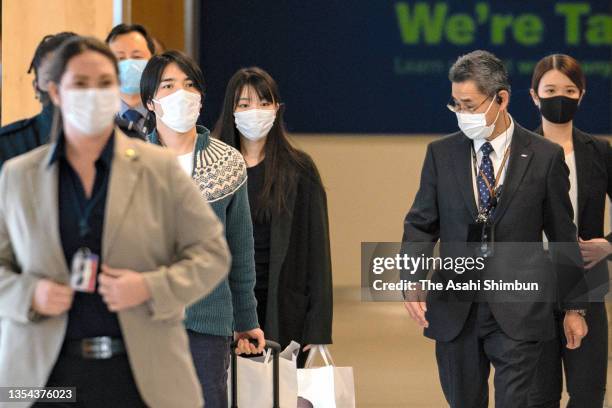 Kei Komuro and Mako Komuro are seen on arrival at John F. Kennedy International Airport on November 14, 2021 in New York City.