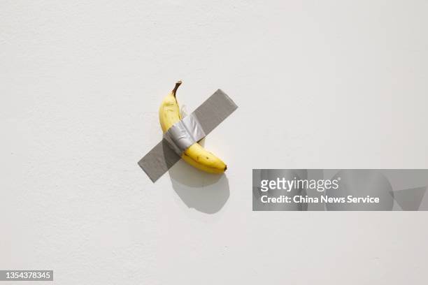 General view shows 'Comedian', a banana duct-taped to a wall, during the solo exhibition 'The Last Judgment' by Italian artist Maurizio Cattelan at...