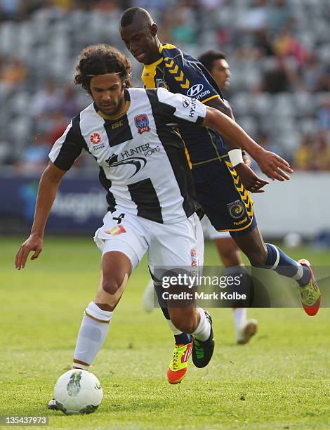 Nikolai Topor-Stanley of the Jets wins the ball from Bernie Ibiniod of the Mariners during the round 10 A-League match between the Central Coast...