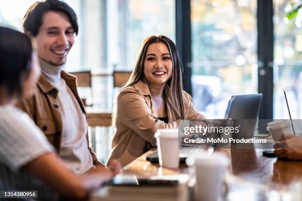 young professionals collaborating in coffeeshop - colleague lunch stock pictures, royalty-free photos & images