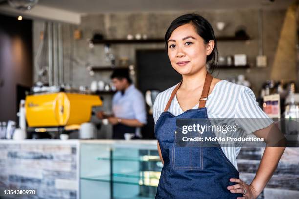 portrait of female coffeeshop owner in coffeeshop - black hair stock pictures, royalty-free photos & images