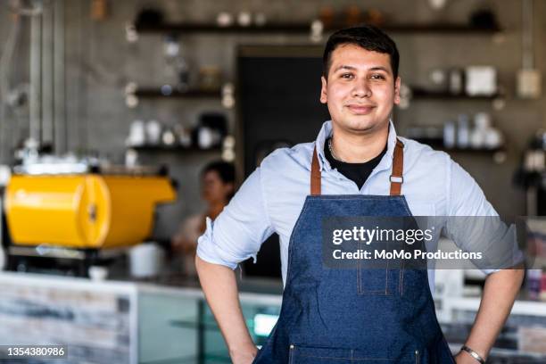 portrait of male coffeeshop owner in coffeeshop - handsome mexican men - fotografias e filmes do acervo