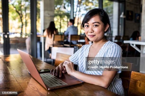 portrait of young professional woman in coffee shop - vietnamese ethnicity stock pictures, royalty-free photos & images