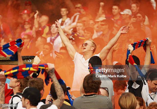 Flare is seen in Newcastle Jets supporters section in the crowd during the round 10 A-League match between the Central Coast Mariners and the...
