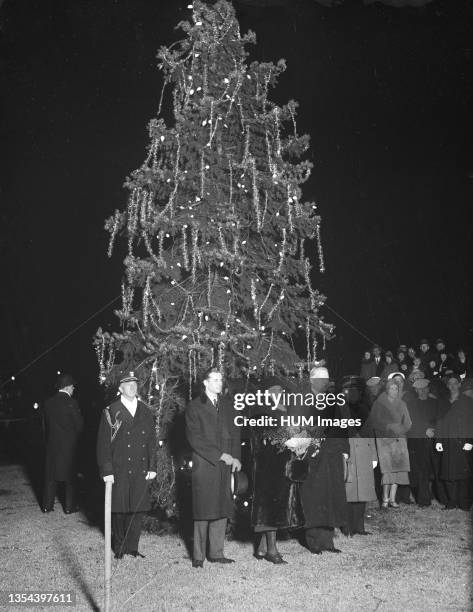 President Hoover pressed the button which lighted Washington's community Christmas tree just before he began his brief 'Merry Christmas' radio...