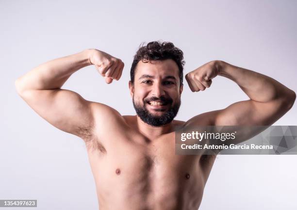 40 year old real man with hair in armpits posing in studio photo - armpit hair stock pictures, royalty-free photos & images