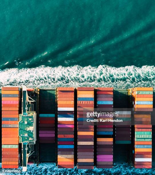 an aerial daytime view of a container ship on the solent sea, uk - stock photo - brexit business stock pictures, royalty-free photos & images