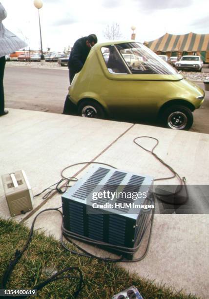 General Motors Urban Electric Car Gets a Battery Charge From an Outlet in the Parking Lot October 1973.