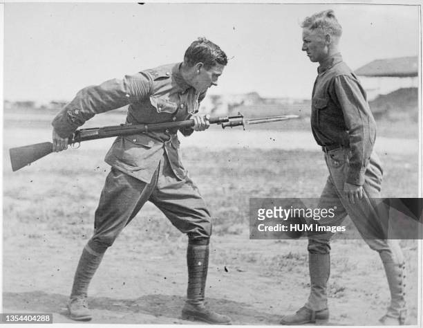 An English Sergeant Major at Camp Dick, Texas teaches bayonet fighting to a soldier before he is shipped out to Europe during World War I.