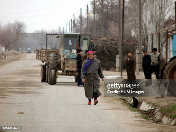Uzbek woman walks down the street during a humanitarian aid assessment visit at Khanabad, Uzbekistan, on Jan. 15 in support of Operation ENDURING...