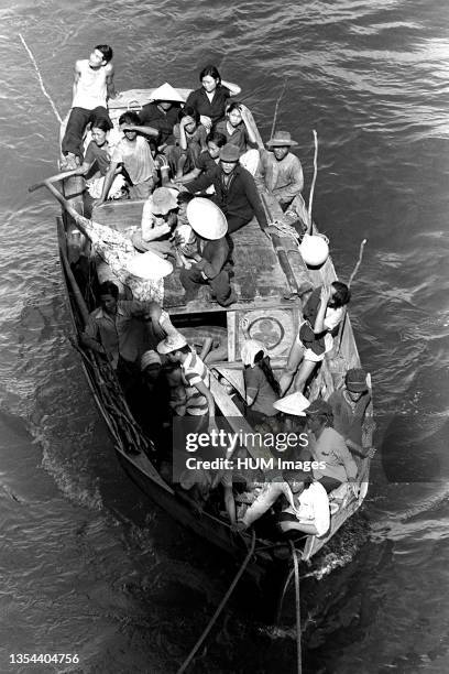 Boat carrying 35 Vietnamese refugees comes along side the amphibious command ship USS BLUE RIDGE . The refugees were rescued 350 miles northeast of...