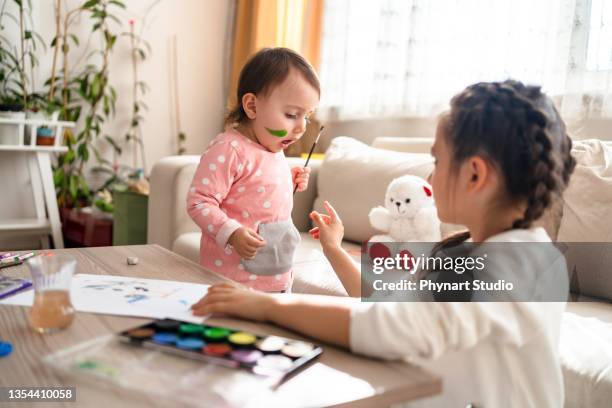 she doesn't want to share with her sister - brothers fighting stock pictures, royalty-free photos & images