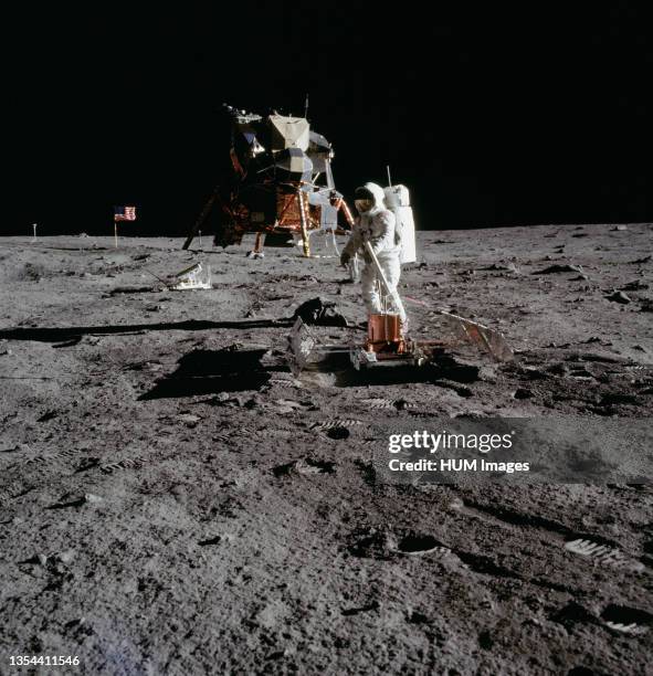 The deployment of the Early Apollo Scientific Experiments Package is photographed by astronaut Neil A. Armstrong, Apollo 11 commander, during the...