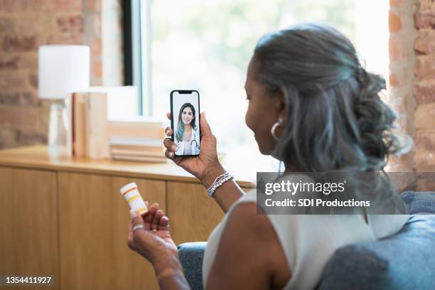 doctor talks with patient during virtual medical appointment - doctor house call stock pictures, royalty-free photos & images