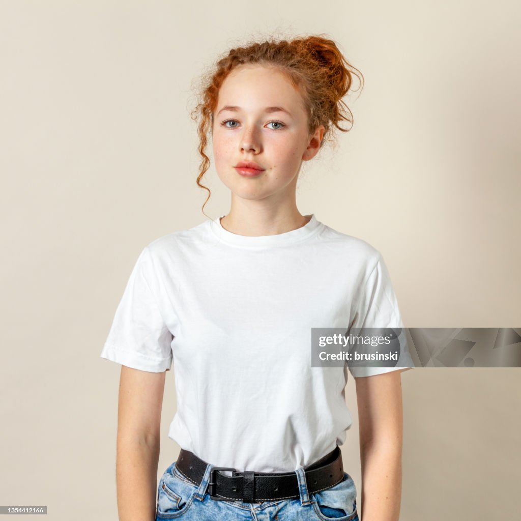 Studio portrait of 15 year old teenage girl with curly red hair