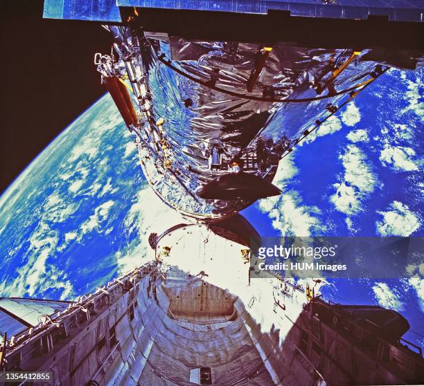 In this photograph, the Hubble Space Telescope is clearing the cargo bay during its deployment on April 25, 1990. The photograph was taken by the...