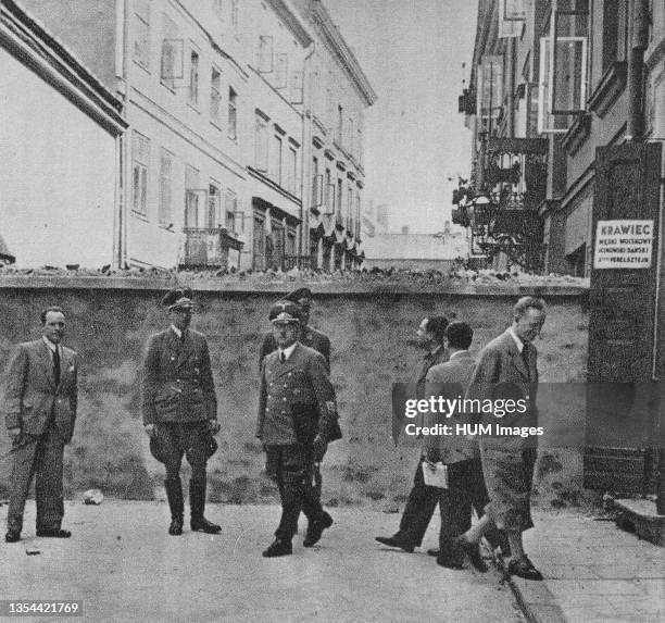 German offcials next to the Warsaw Ghetto wall ca. 1941.