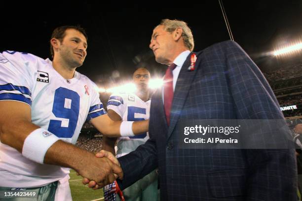 Former United States President George W. Bush meets with Quarterback Tony Romo of the Dallas Cowboys when he participates in pregame activities to...