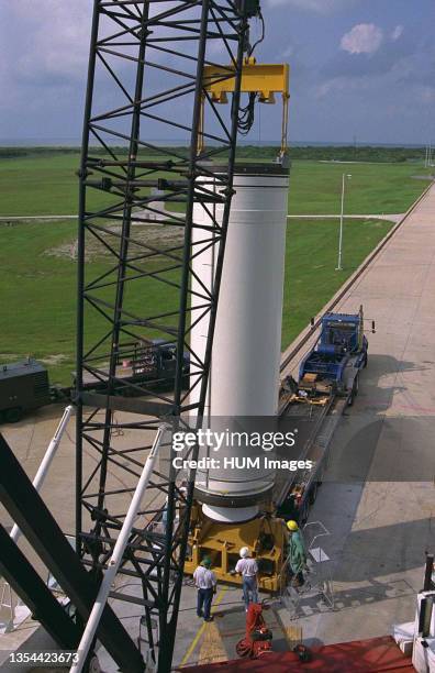 Workers hoist the first stage of a Lockheed Martin Launch Vehicle-2 for placement at Launch Complex 46 at Cape Canaveral Air Station , Fla. The Lunar...