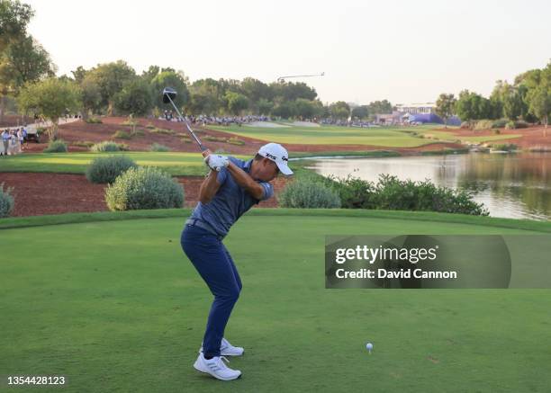 Collin Morikawa of The United States plays his tee shot on the 18th hole during the third round of The DP World Tour Championship on The Earth Course...