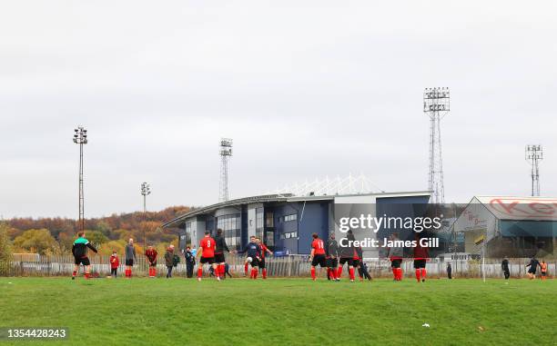 An amateur team warm up on the pitch outside the stadium prior to the Sky Bet League Two match between Oldham Athletic and Port Vale at Boundary Park...