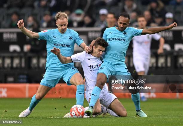 Haavard Nielsen and Julian Green of SpVgg Greuther Fuerth battle for possession with Florian Neuhaus of Borussia Moenchengladbach during the...