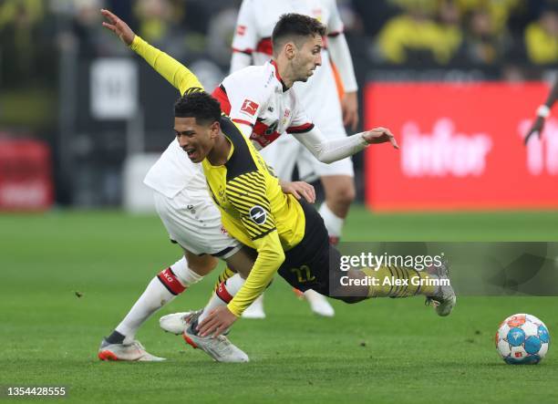 Jude Bellingham of Borussia Dortmund is fouled by Atakan Karazor of VfB Stuttgart during the Bundesliga match between Borussia Dortmund and VfB...