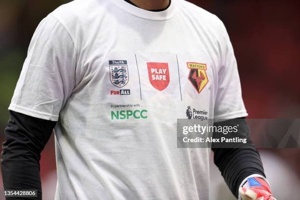 Player is seen warming up wearing a t-shirt in support of the 'Play Safe' campaign during the Premier League match between Watford and Manchester...