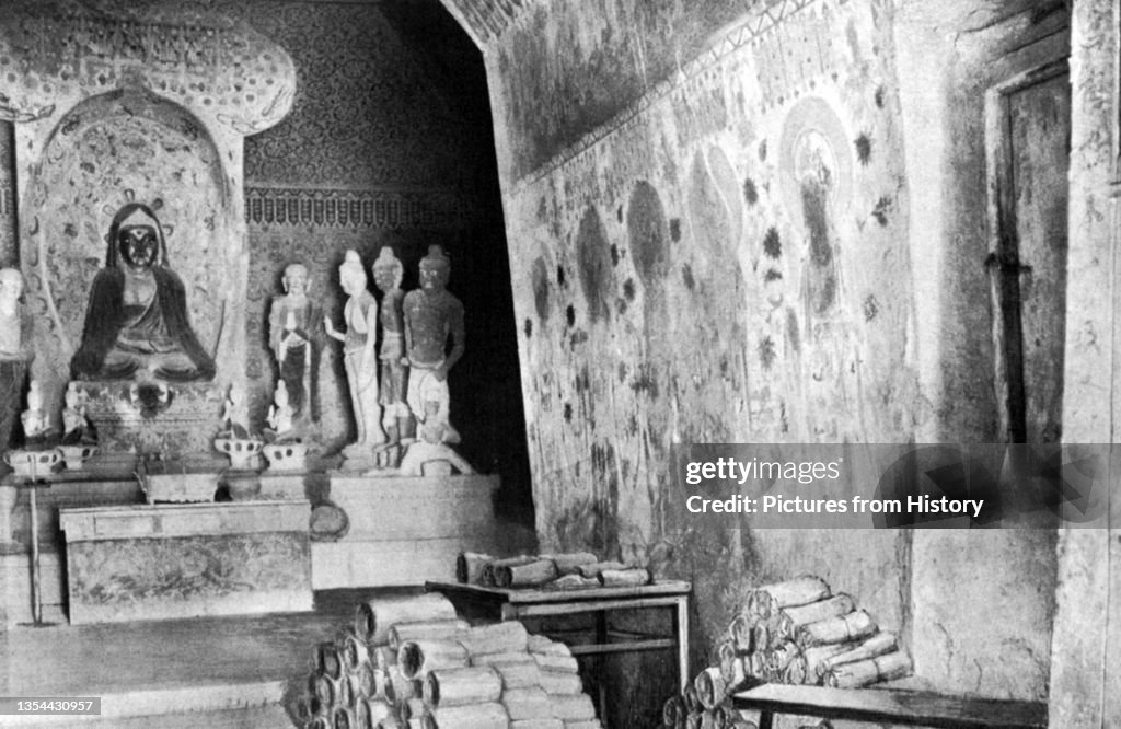 China: Documents from Cave 17, Mogao, piled up for examination by Sir Aurel Stein. Dunhuang, 1908.